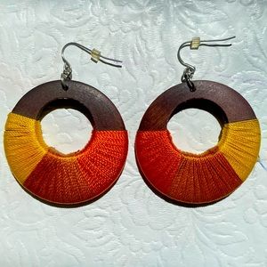 Wooden hoop earrings with orange, tan & yellow thread wrap.